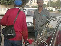 Petrol pump attendant filling tank