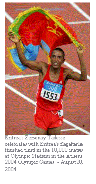 Text Box:  
Eritrea's Zersenay Tadesse celebrates with Eritrea's flag after he finished third in the 10,000 metres at Olympic Stadium in the Athens 2004 Olympic Games  - August 20, 2004
