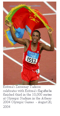 Text Box:  
Eritrea's Zersenay Tadesse celebrates with Eritrea's flag after he finished third in the 10,000 metres at Olympic Stadium in the Athens 2004 Olympic Games  - August 20, 2004
